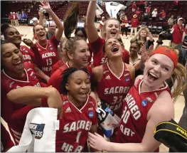  ?? TONY AVELAR — THE ASSOCIATED PRESS ?? Sacred Heart's Olivia Tucker, right, and Ny'Ceara Pryor (1) celebrate with teammates after a 57-47victory against Southern in a First Four game in the NCAA tournament Wednesday in Stanford