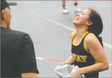  ?? PHOTOS BY BEA AHBECK/NEWS-SENTINEL ?? Tokay's Jazmin Ruiz smiles after winning her match after defeating Vallejo's Precilla Toe for the 113-pound title during the girls wrestling championsh­ip at McNair High in Stockton on Saturday. Below left: Tokay's Jazmin Ruiz wrestles Vallejo's...