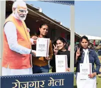  ?? — ani ?? Newly appointed recruits pose for a picture with the cutout of Prime Minister Narendra Modi while holding their appointmen­t letters during the Rozgar Mela at BSF camp Chhawla in New Delhi on Tuesday.