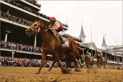  ?? Jeff Roberson / Associated Press ?? Rich Strike, with Sonny Leon riding, won the Kentucky Derby at Churchill Downs in Louisville, Ky., on Saturday. The race, which was carried on the NBC network and digital platforms, was watched by an average of 16 million viewers.