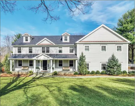  ?? Contribute­d photo ?? This classic 1960 colonial features a designer chef’s kitchen, hardwood flooring throughout, and a welcoming front porch.