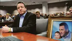  ?? Hearst Connecticu­t Media ?? Sandy Hook victim father Neil Heslin, with a photo of his son, Jesse.