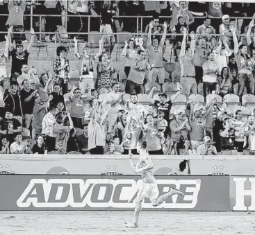  ?? Thomas B. Shea ?? The Dynamo’s Erick Torres acknowledg­es an adoring audience after scoring his final goal in added time Saturday night to complete a hat trick in a 4-1 win over the New York Red Bulls at BBVA Compass Stadium.