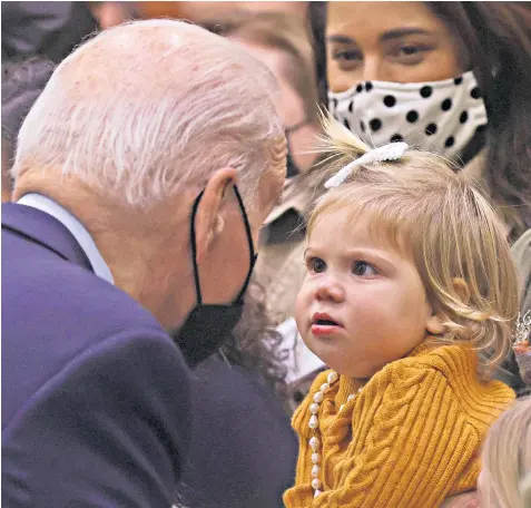  ?? ?? Joe Biden, who captivated a toddler at a Thanksgivi­ng event for military families at Fort Bragg, North Carolina, maintains that he will seek re-election if Donald Trump runs in 2024