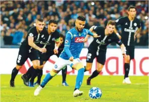  ?? (Reuters) ?? Napoli’s Lorenzo Insigne (foreground) in action during the UEFA Champions League match against Paris Saint-Germain in Naples, Italy, on Tuesday.