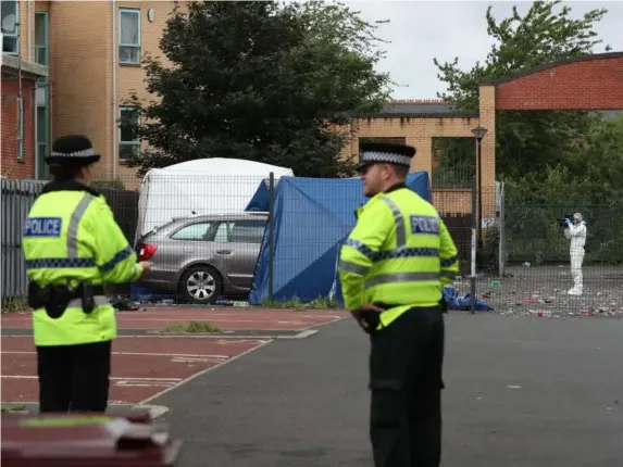  ??  ?? A forensic tent at the scene partially covers a Skoda car in a courtyard (PA)