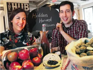  ?? BRUNO SCHLUMBERG­ER/OTTAWA CITIZEN ?? Katrina Siks and Jason Garlough harvest fruits and nuts that would otherwise go to waste.