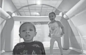  ?? COURTESY OF LATRICE KNIGHTON ?? Eli and Laila Knighton enjoy their bounce house. Their mother, Latrice Knighton, uses the bounce house to entertain them while she works from home during the pandemic.