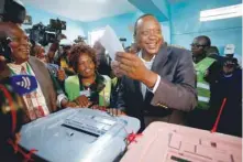  ?? — Reuters ?? President Uhuru Kenyatta casts his ballot in his hometown of Gatundu in Kiambu county on Tuesday.