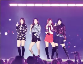  ??  ?? WORK IT. The iconic BlackPink members striking a pose after their song Playing With Fire + As If It’s Your Last.
