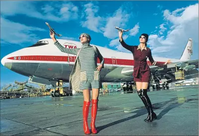  ?? ?? Models posing on a tarmac in front of a TWA Boeing 747 play with toy models of worldchang­ing plane in 1970
