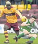  ??  ?? Kip off the old block Cedric Kipre gets to grips with Hibee John McGinn