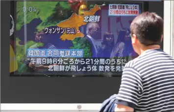  ??  ?? Photo shows a man watches a television screen showing a news report on North Korea firing several short-range projectile­s from its east coast, on a street in Tokyo, Japan. — Reuters photo