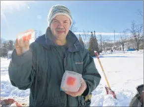  ?? COLIN CHISHOLM ?? Paul Morton, organizer of the Hantsport Winter Carnival, uses a saw to trim down one of the blocks for the igloo.