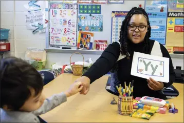  ?? JULIA NIKHINSON — THE ASSOCIATED PRESS ?? Student teacher Lana Scott, who plans to graduate from Bowie State University in the spring, teaches a small group of kindergart­ners at Whitehall Elementary School in Bowie, Md., on Jan. 24.