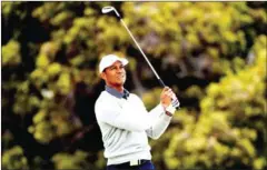  ?? AFP ?? US team captain Tiger Woods watches his shot to the green during Day 2 of the Presidents Cup golf tournament in Melbourne on December 13, 2019.