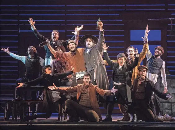  ?? JOAN MARCUS ?? Yehezkel Lazarov (as Tevye, center, smiling in brown), with Jonathan Von Mering (in black), and the touring cast of “Fiddler on the Roof.”