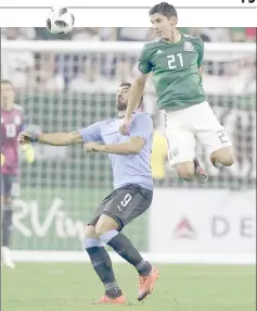  ?? AFP photo ?? Jesus Angulo (right) of Mexico goes up for a header over Luis Suarez of Uruguay in the first half during a friendly match at NRG Stadium in Houston. —