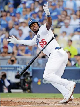  ?? [AP PHOTO] ?? Los Angeles Dodgers’ Yasiel Puig reacts after hitting an RBI single during the sixth inning of Game 5 of the National League Championsh­ip Series against Milwaukee on Wednesday in Los Angeles.