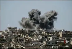  ??  ?? This July 5 file photo provided by Nabaa Media, a Syrian opposition media outlet, shows smoke rising over buildings that were hit by Syrian government forces bombardmen­t, in Daraa province, southern Syria. nAbAA MedIA VIA AP