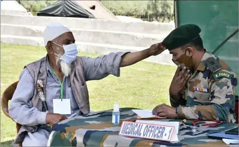  ?? ANI ?? An old man blesses an Army doctor during a medical cum veterinary camp organized by the Indian Army at Kotlari, in Kupwara on Saturday.