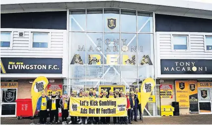  ?? ?? Campaigner­s The Big Step group, stopped at Livingston FC’s stadium on a 60-mile campaign walk across Scotland