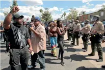  ?? PHOTO: REUTERS ?? Protesters confront San Diego sheriff’s deputies near the site where Alfred Olango was fatally shot by police in El Cajon, California.