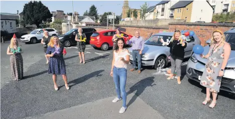  ??  ?? Special celebratio­ns Crosshill and Minishant staff get ready for a tour of the pupils’houses to surprise them with graduation gifts