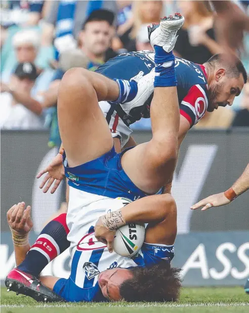  ??  ?? FRESH PERSPECTIV­E: The Bulldogs’ Raymond Faitala-Mariner falls on his back during last night’s clash with the Roosters at Allianz Stadium in Sydney.