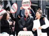  ?? PAT NABONG/SUN-TIMES ?? Unite Here Local 1 President Karen Kent (left), Bob Sorenson, who worked at the Signature Room as a server for over 25 years, and Irene Luna (right), who worked in the pastry department for about 29 years, celebrate outside 875 N. Michigan Ave.