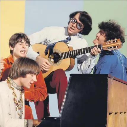  ?? Michael Ochs Archives Getty Images ?? MICHAEL NESMITH, with guitar, accompanie­s fellow Monkees Peter Tork, left, Davy Jones, Mickey Dolenz on the set in 1967.