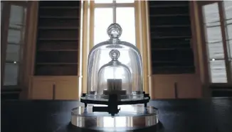  ??  ?? A replica of the Internatio­nal Prototype Kilogram is pictured at the Internatio­nal Bureau of Weights and Measures, in Sevres, near Paris. The golf ball-sized metal cylinder at the heart of the world's system for measuring mass is heading into retirement.