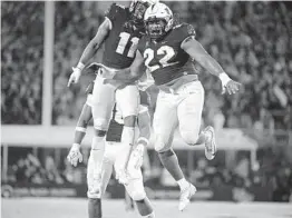  ?? PHELAN M. EBENHACK/AP ?? UCF defensive lineman Kalia Davis (22) and linebacker Jeremiah Jean-Baptiste celebrate during their season-opening victory against Boise State.