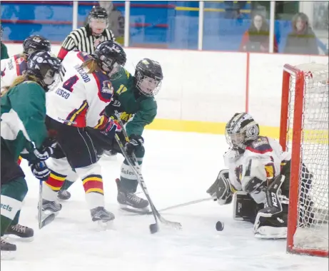  ?? KEVIN ADSHADE/THE NEWS ?? Julia MacDonald (17) of the Fundy Highland PeeWee AA Selects crashes the net and scores a goal against Metro East Inferno on Friday at Hector Arena.