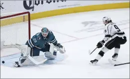  ?? BENJAMIN FANJOY — THE ASSOCIATED PRESS ?? The Kings’ Adrian Kempe, right, scores against San Jose goalie Mackenzie Blackwood in the first period of Thursday’s game in San Jose. The Kings went on to a 2-1victory. For coverage and more on the Kings, go to