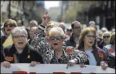  ?? Manu Fernandez The Associated Press ?? People march and chant slogans during a protest Saturday by pensioners in Barcelona, Spain.