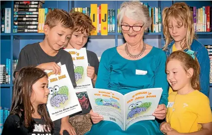  ?? VANESSA LAURIE/STUFF ?? The Rock Pool Writers Collective are a group of 7-year-old writers from Inglewood Primary School. Pictured, from left, are Olivia Beasenman, Grayson Young, Daxtyn Ferguson, literacy volunteer Robin Drake, Alice Williams (back) and Indigo Feasey.