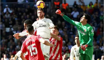  ??  ?? Real Madrid’s Sergio Ramos (top) in action with Girona’s Bono during the Spanish La Liga match at the Santiago Bernabeu stadium in Madrid. — Reuters photo