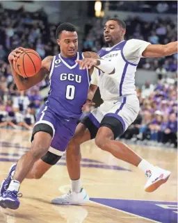  ?? PATRICK BREEN/THE REPUBLIC ?? GCU guard Ray Harrison (0) drives against ACU forward Joe Pleasant (32) during Friday’s game at GCU.