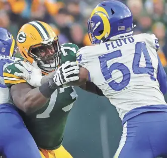  ?? MARK HOFFMAN / MILWAUKEE JOURNAL SENTINEL ?? Packers left tackle Yosh Nijman, making his fourth start of the season Sunday, blocks Rams linebacker Leonard Floyd.