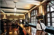  ?? MARCO LONGARI / AGENCE FRANCE-PRESSE ?? Sello Chauke, the barman of the Rand Club, a relic of South Africa's colonial history, leans on the bar in Johannesbu­rg on Dec 6.