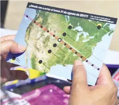 ??  ?? A woman views a map showing the route of the sun crossing the United States during the Solar Eclipse Festival at the California Science Center in Los Angeles. — AFP photo