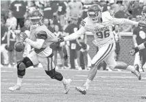  ??  ?? Baker Mayfield Ahmad Thomas Quarterbac­k Kyler Murray, left, is stopped by a touch by Dalton Rodriguez during the spring football game. Rodriguez played at Tulsa and went to Tulsa Union.