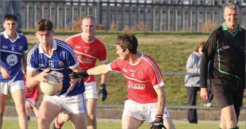  ??  ?? Referee Martin Armstrong keeps watch as Fiachra Hourihane (Oylegate-Glenbrien) is tackled by Niall O’Reilly (Monageer-Boolavogue).