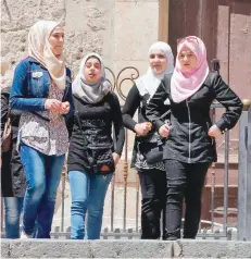  ?? — AFP ?? Syrian girls venture out in the old city of Damascus. The advances of government forces have helped the regime to widen the security belt around Damascus.