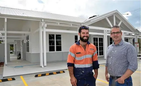  ??  ?? WHAT A HOUSE: Hutchinson Builders’ site manager Damian Mills (left) and Pradella Property Ventures’ Alex McMahon stand outside the $1.7m Summer House, which is close to completion at Seachange Toowoomba Lifestyle Resort on Hampton St in Harristown.