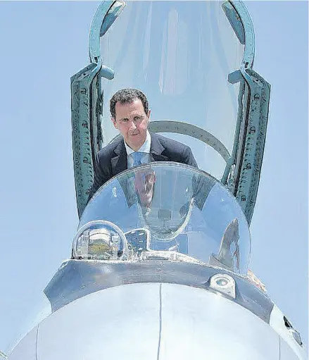  ?? SYRIAN PRESIDENCY FACEBOOK PAGE / AFP / GETTY IMAGES ?? Syrian President Bashar al-Assad sits inside a Sukhoi Su-27 during his visit to the Hmeimim military base in the northwest Syria. Russian military backing has been essential to Assad’s hold on power.