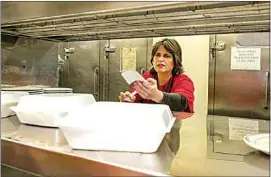  ??  ?? Kathy Exarchoula­kos takes an order at the Golden Ox Diner she and her husband, Ted, own on Wilson Road.