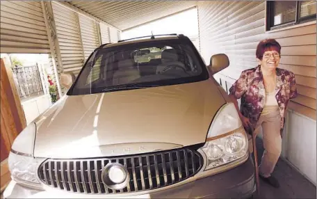  ?? GenaroMoli­na Los Angeles Times ?? JENNIFER JORDAN, 58, of Lemoore, Calif., is happy to have her 2005 Buick Rendezvous back. It was confiscate­d after she was unable to keep up with loan payments to a storefront title lender, Allied Cash Advance, which had lent hermuch more money than...