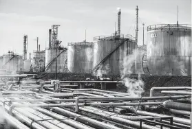  ?? Akos Stiller / Bloomberg ?? Storage tanks stand in the Duna oil refinery, operated by MOL Hungarian Oil &amp; Gas Plc, on Monday in Szazhalomb­atta, Hungary.